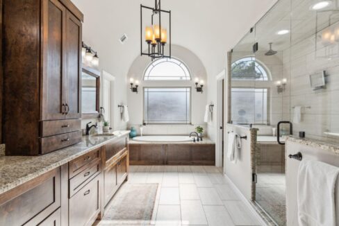 2413 Versailles Drive Heath, TX primary bathroom with tub and shower