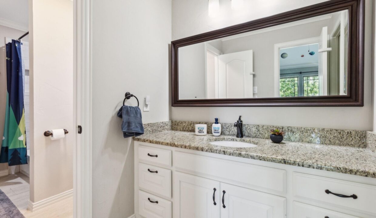 2413 Versailles Drive Heath, TX bathroom with large mirror